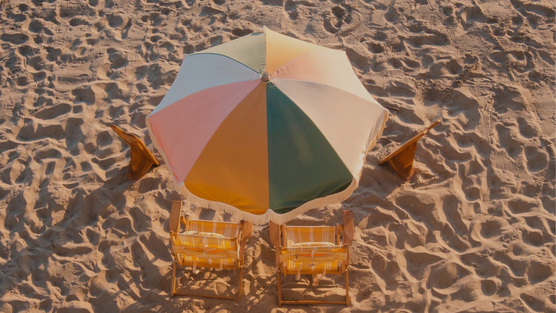 A Beach With Chairs And Umbrella