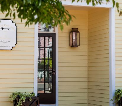 A House With A Gate And A Sign On The Door