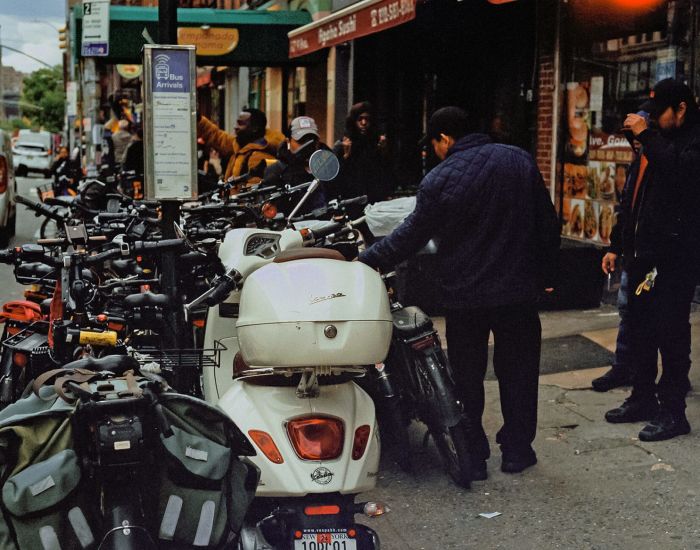 A Group Of Motorcycles Parked On The Side Of A Street