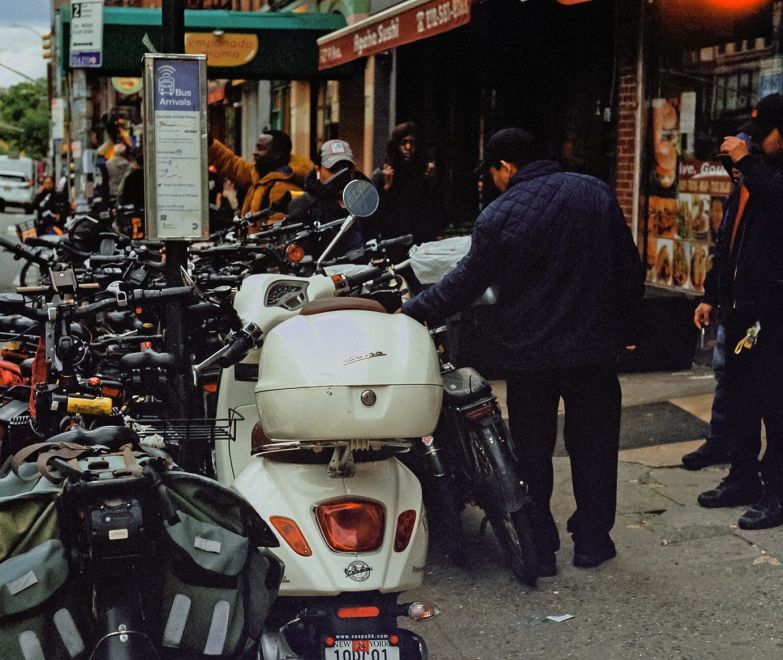 A Group Of Motorcycles Parked On The Side Of A Street