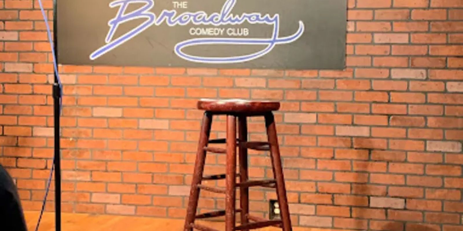 A Stool And A Painting On A Brick Wall