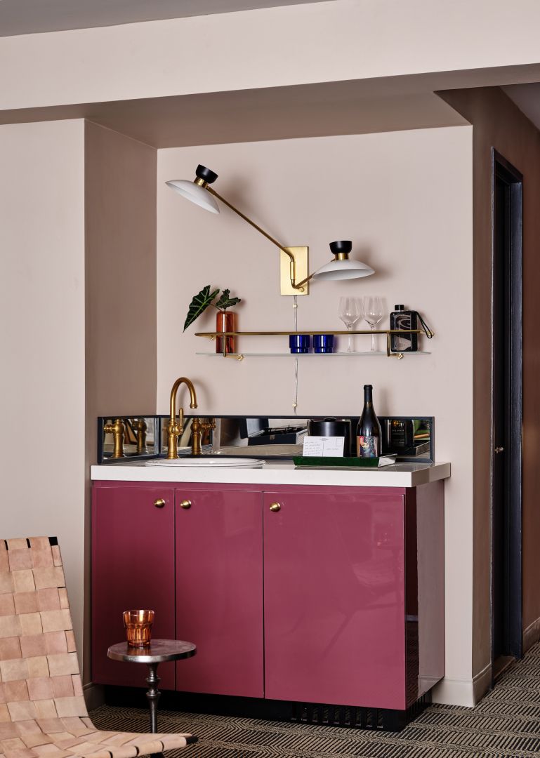 A Kitchen With A Pink Cabinet