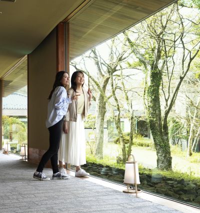 A Man And Woman Standing Outside A Building