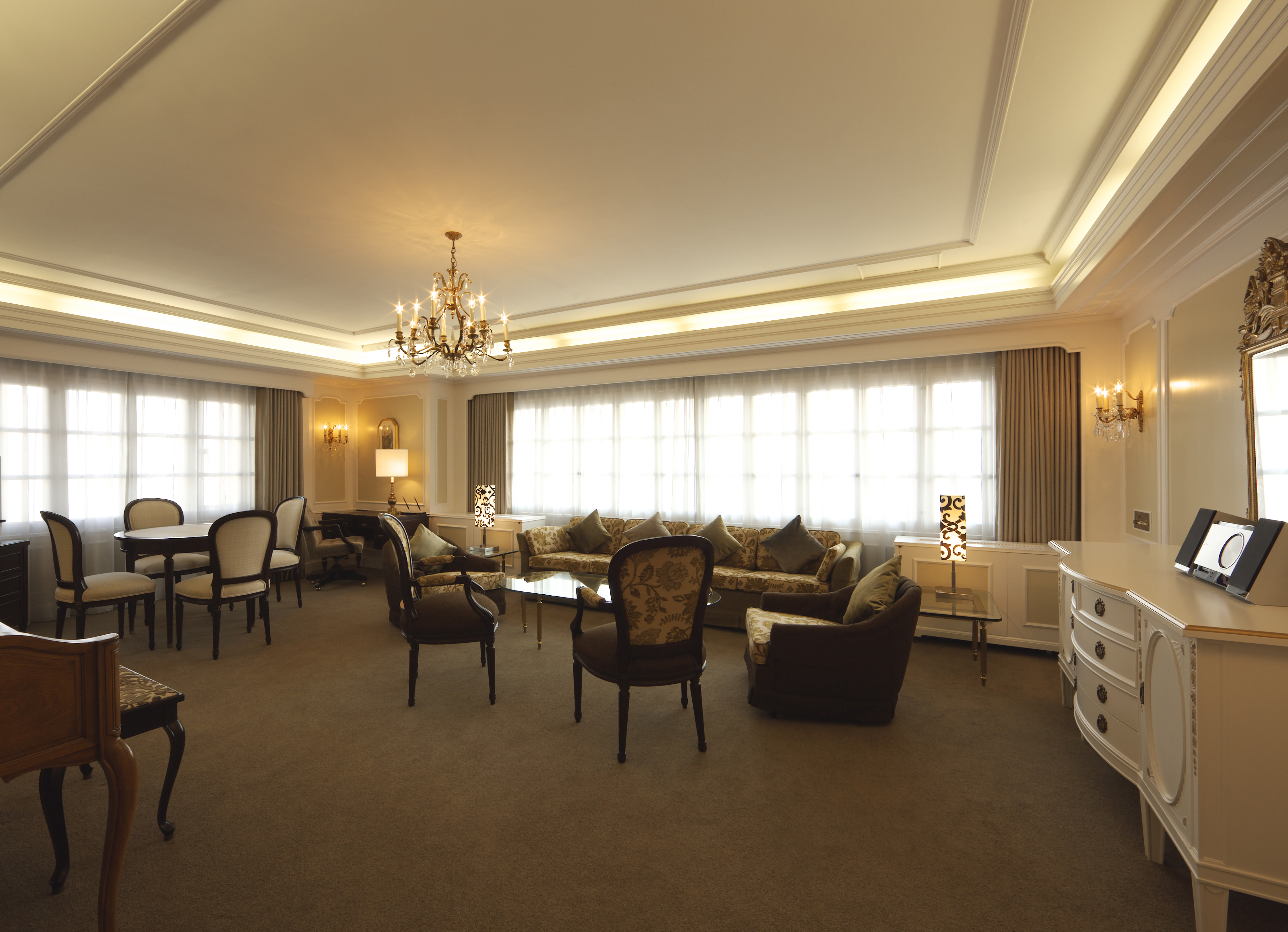 A Room With A Chandelier And Chairs