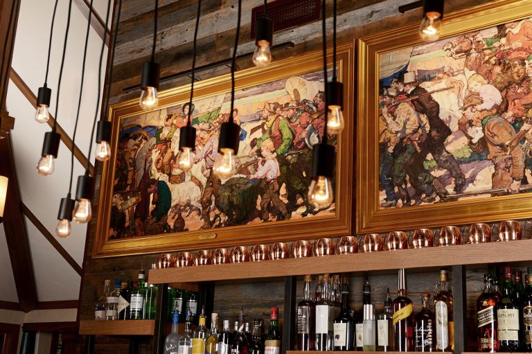 A Bar With A Large Painting