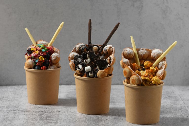 A Group Of Small Cups With Sticks In Them