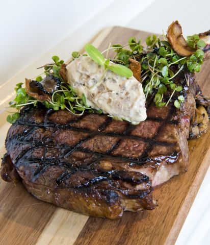 A Piece Of Cooked Meat On A Wooden Surface