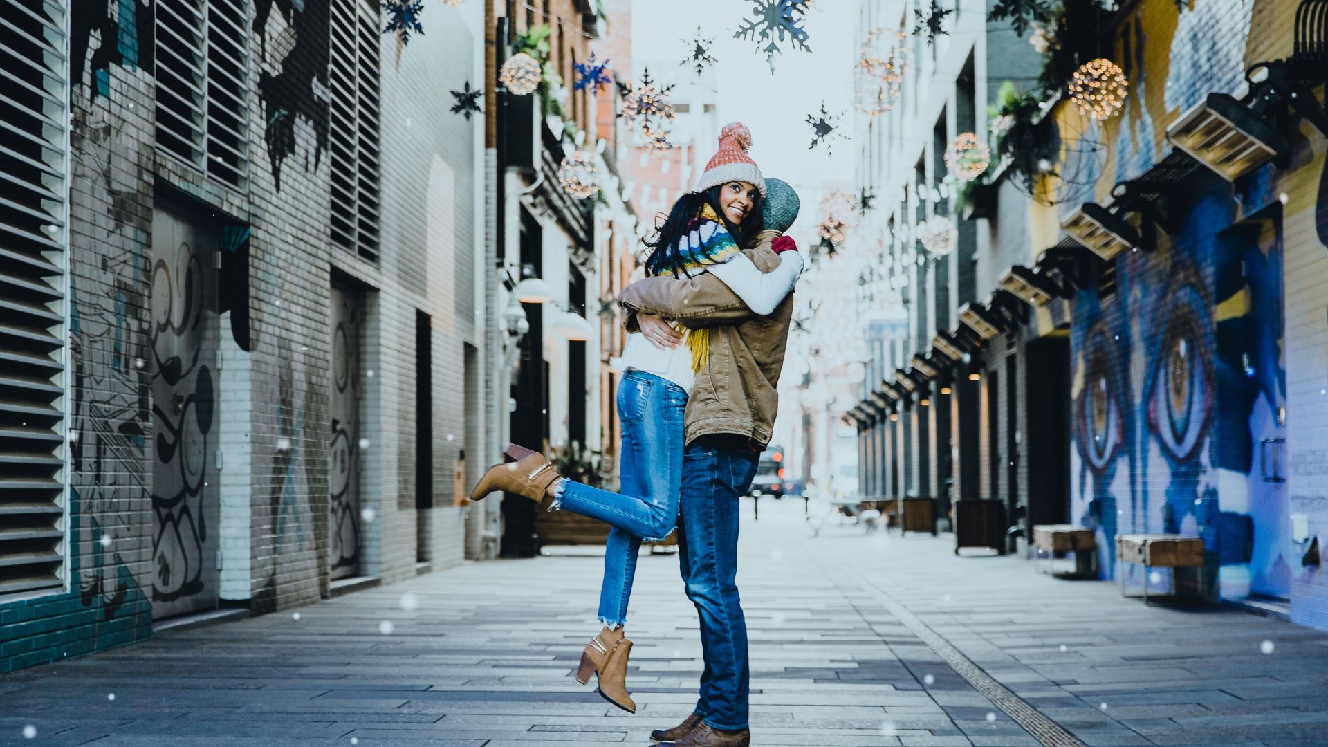A Man And Woman Dancing In A Alley Between Buildings