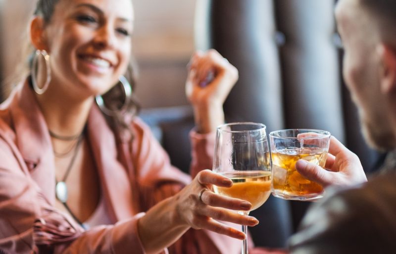 A Woman Holding A Glass Of Wine