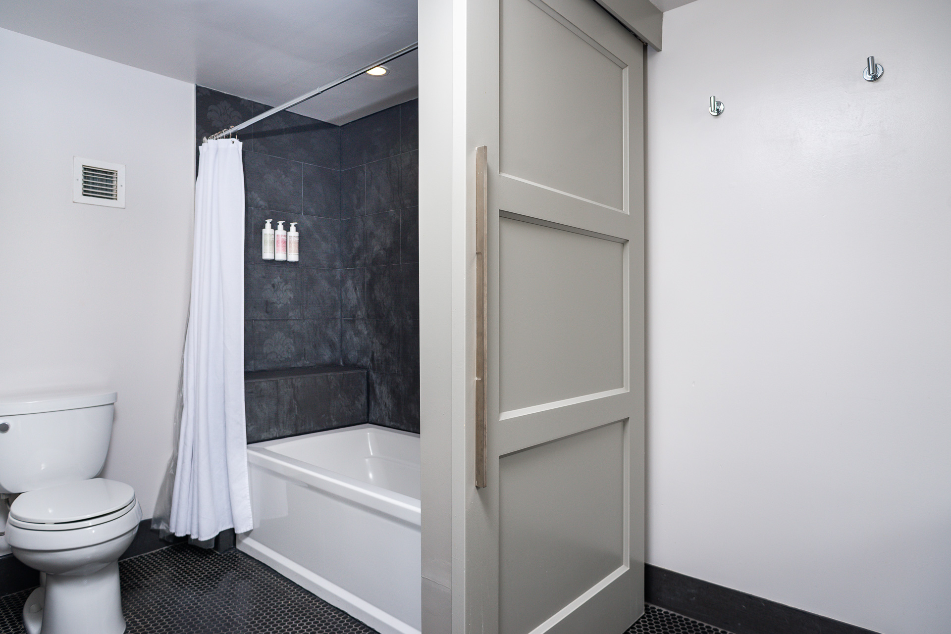 A Bathroom With A Bathtub Toilet And Shower