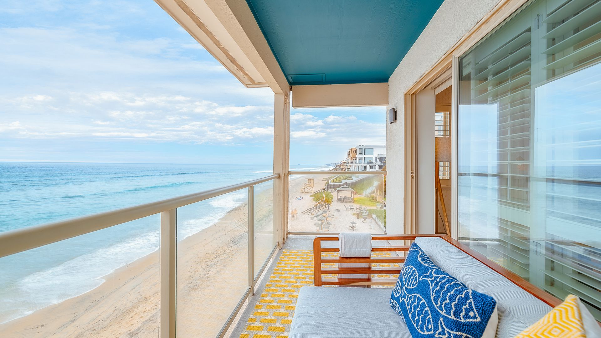 A Deck With A View Of The Ocean And A Beach