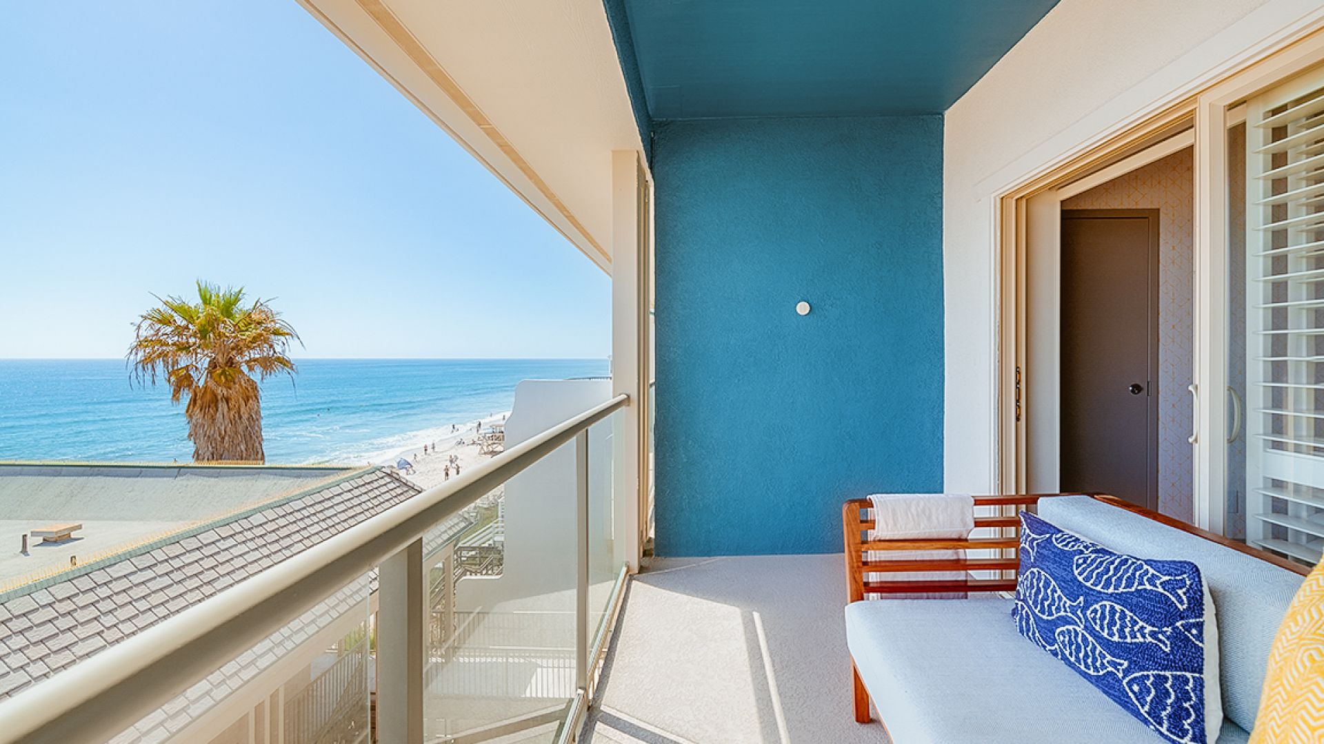 A Balcony With A View Of The Ocean And A Beach