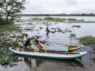 A Group Of People On A Boat In A River