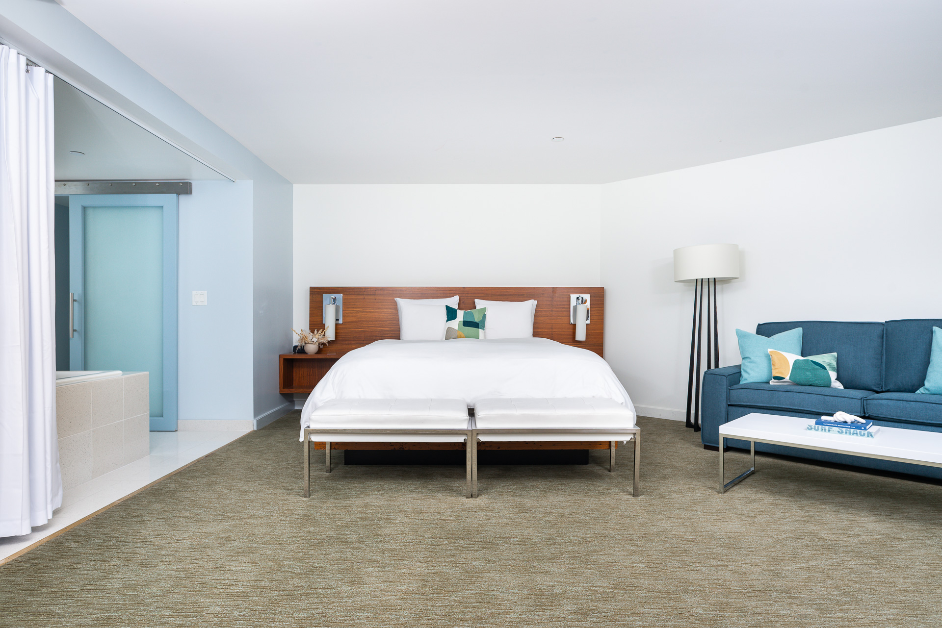 A Bedroom With A Bed And A Couch